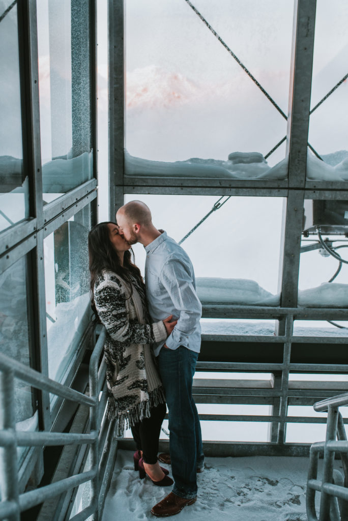 Couple in industrial staircase for engagement session at Alyeska Resort