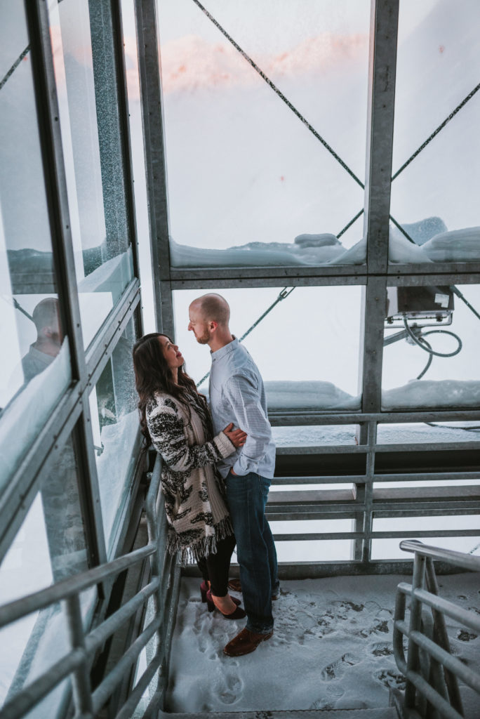 Couple in industrial staircase for engagement session at Alyeska Resort