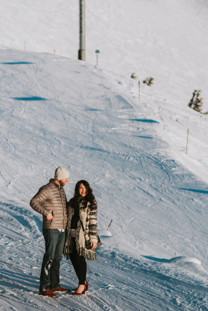 A man proposing to his girlfriend on the top of snow mountainside at alyeska resort, she said yes