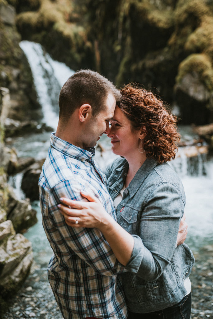 couple leaning their foreheads together at virgin creek falls