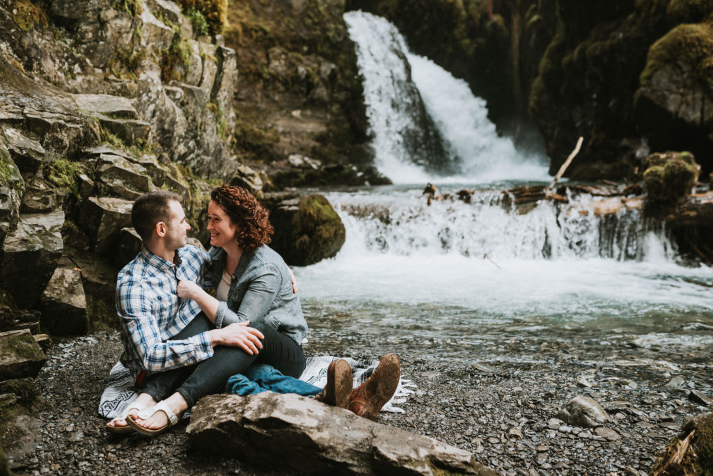 couple snuggling and laughing at virgin creek falls