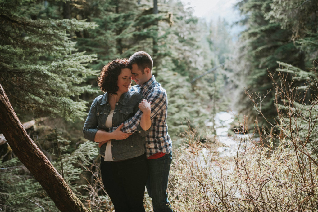 couple hugging and snuggling during engagement session in girdwood