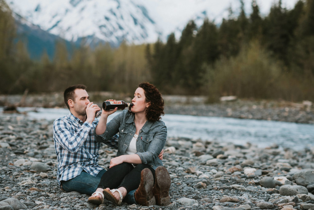couple throwing back some beer during their girdwood engagement session