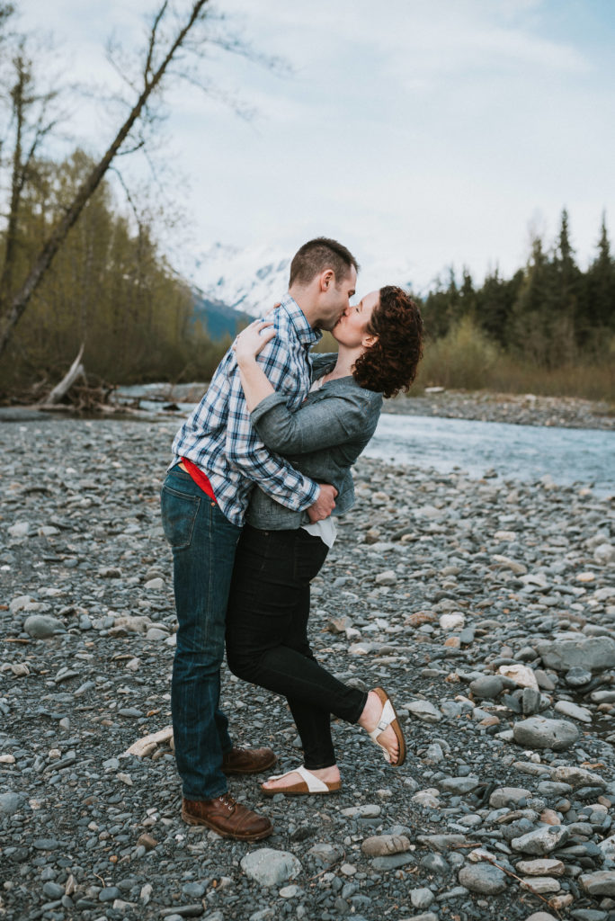 couple hugging and kissing on riverbed