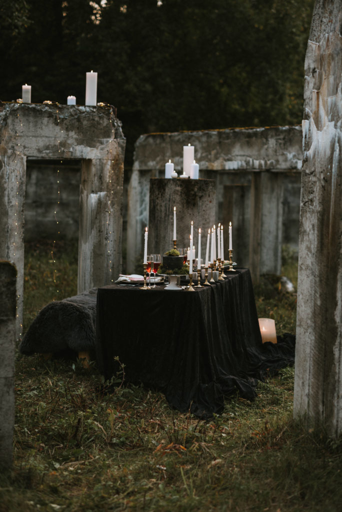 Beautifully done up table with black velvet table cloth and candles and flowers