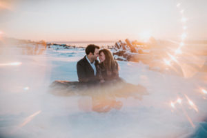 Camera prism flare at sunset around couple