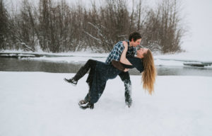 Couple dip kissing in the snow