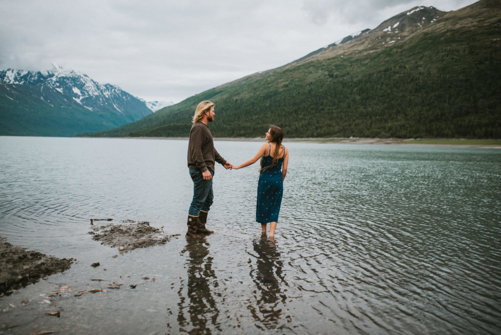 Couple walking into the water holding hands