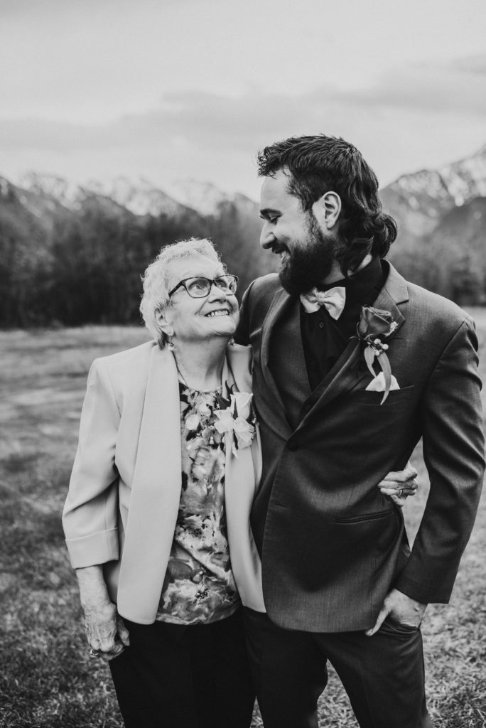 Groom and grandmother smiling at each other