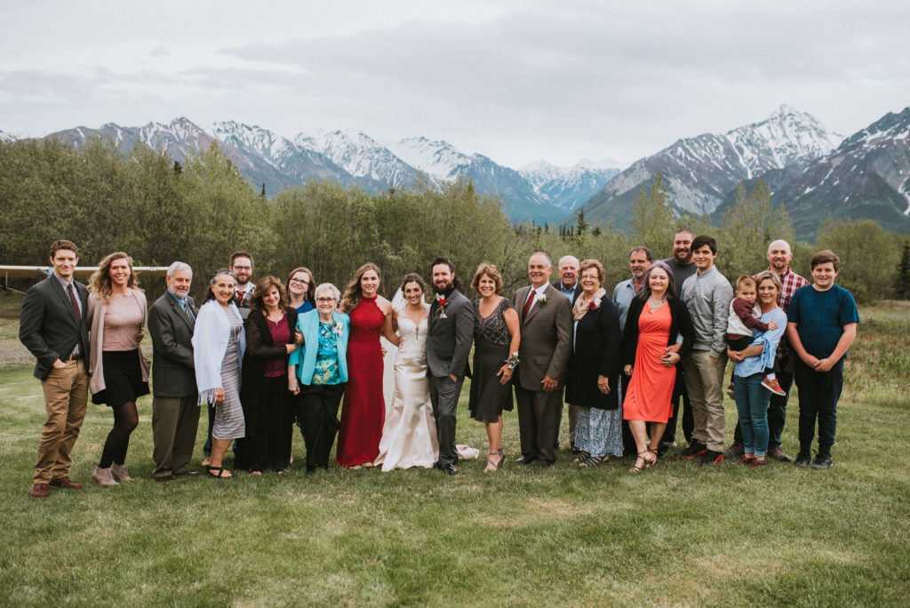 Entire family at wedding against mountains