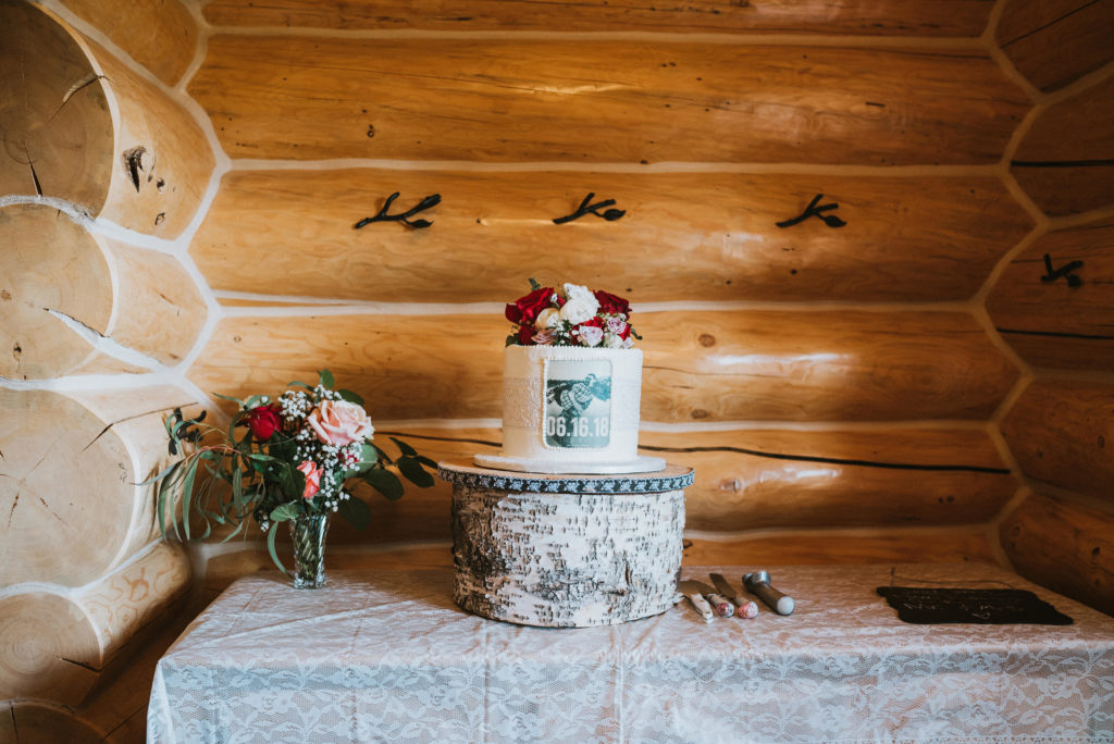 Wedding cake with cabin log back ground