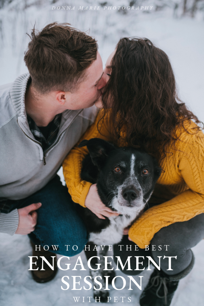 Couple kissing each other while snuggling their dog during their engagement session