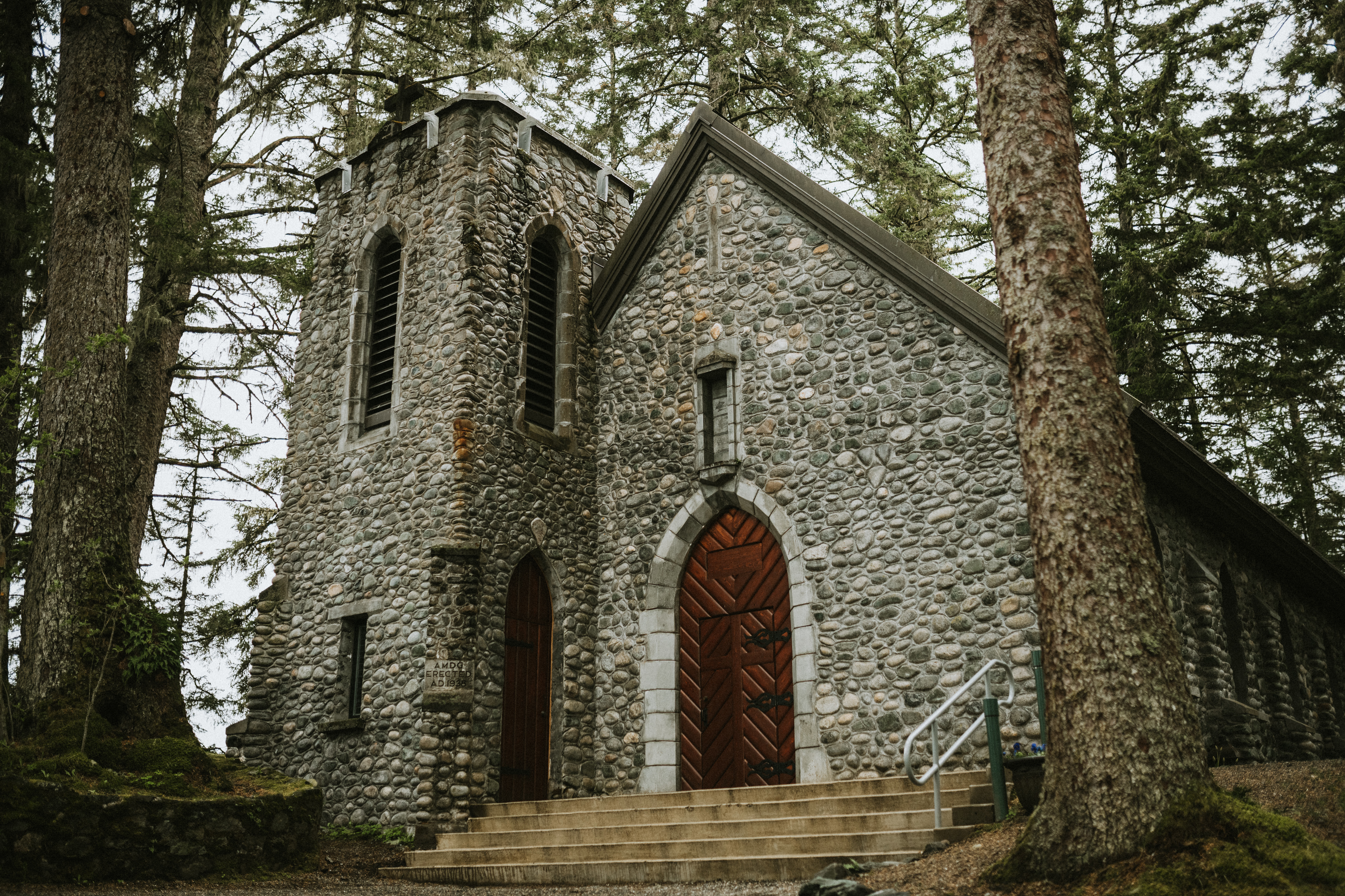 Stone chapel in lush green forest of Juneau, Alaska. Shrine of St Therese