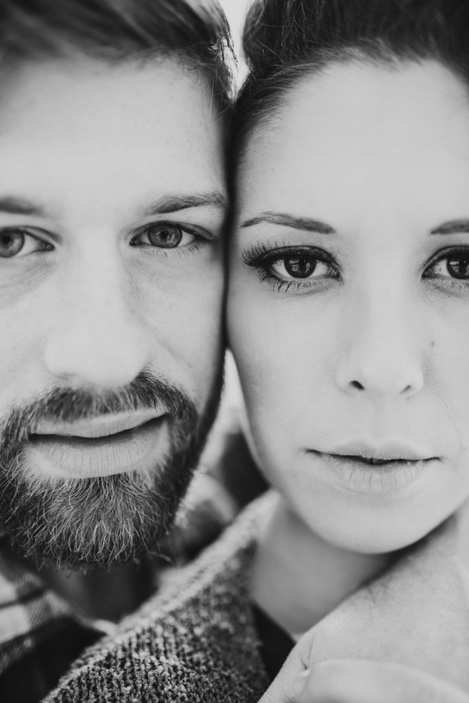 Black and white of a couple with their cheeks pressed together for a serious photo of their eyes by Donna Marie Photography.