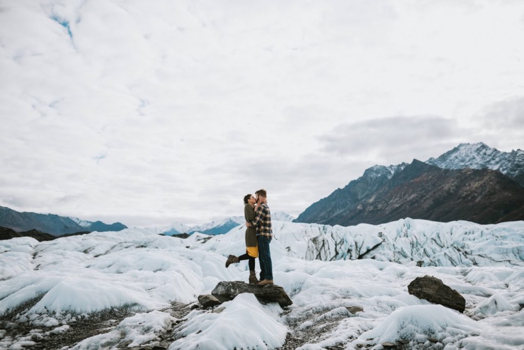 Couple laughing and smiling during fun glacier engagement session by Donna Marie Photography.