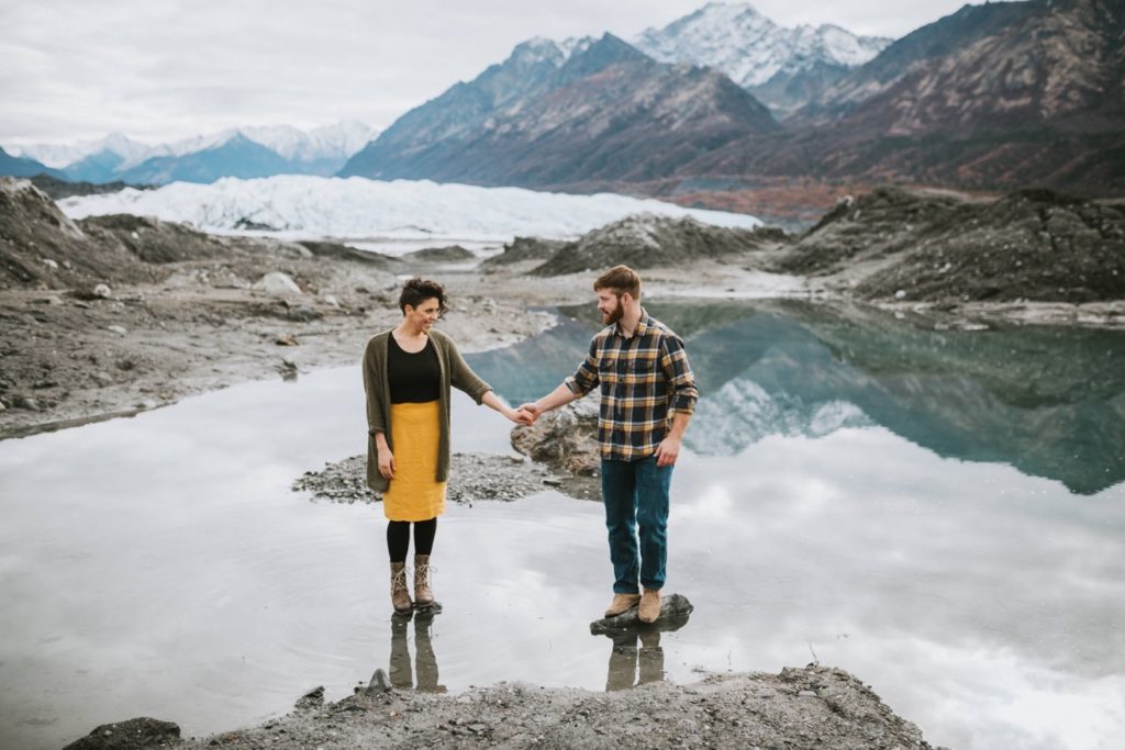 Couple standing in glacier lake at Matanuska Glacier Park by Donna Marie Photography.