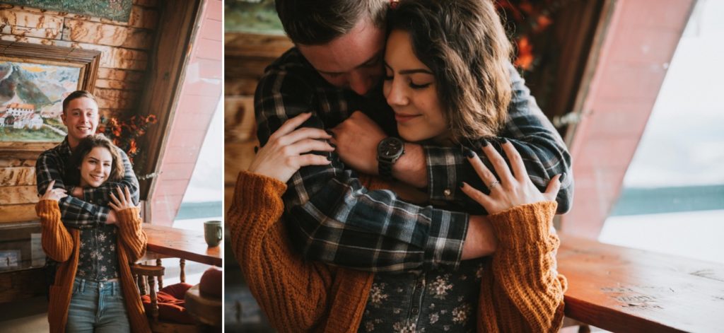 Couple hugging inside hatcher Pass Lodge wearing flannel and cardigan