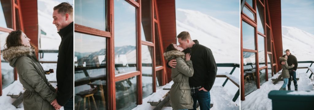 Couple kissing in front of iconic Hatcher Pass Lodge in Alaska