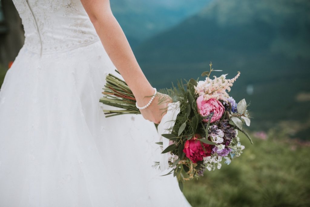 Bride holding bouquet of flowers at Alyeska elopement.