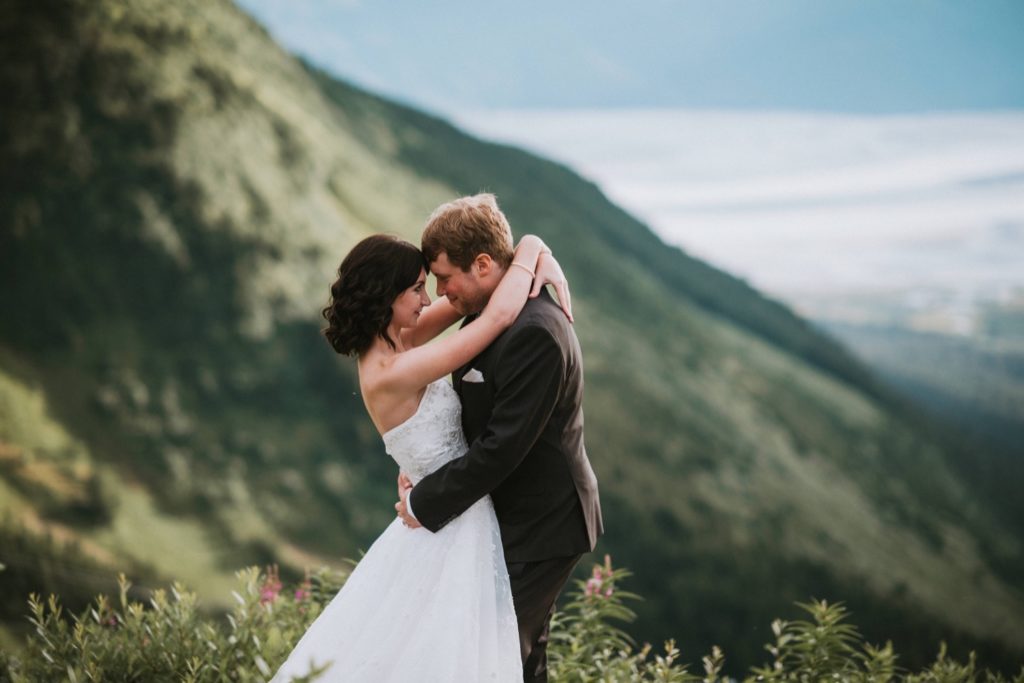 Couple hugging on mountain top at Alyeska Resort in Girdwood