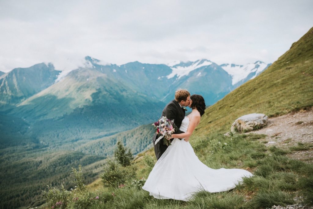 Couple kissing on mountain top at Alyeska Resort in Girdwood