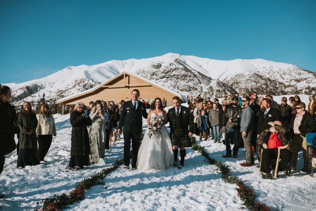 Bride walking down the aisle at Alaska winter wedding ceremony