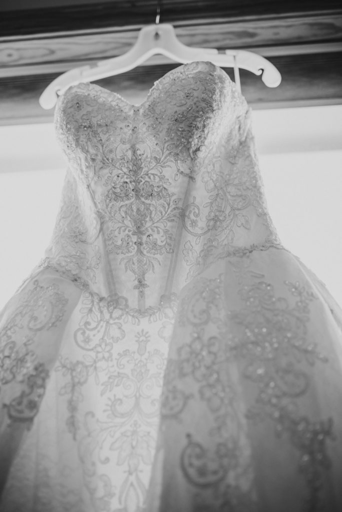 Black and white photo of dress hanging in window
