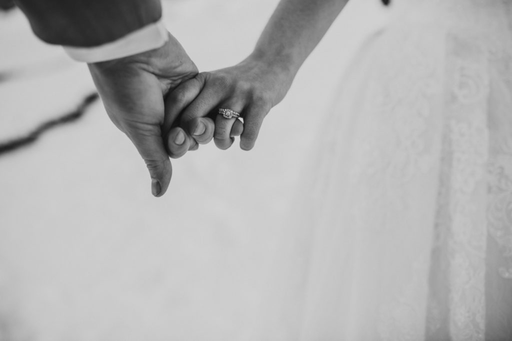 Bride and groom holding hands during wedding