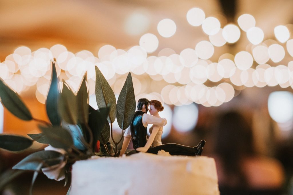 Cake topper of bride and groom on wedding cake