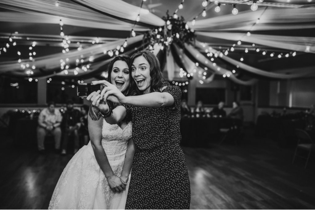 Bride and best friend taking a selfie at the wedding