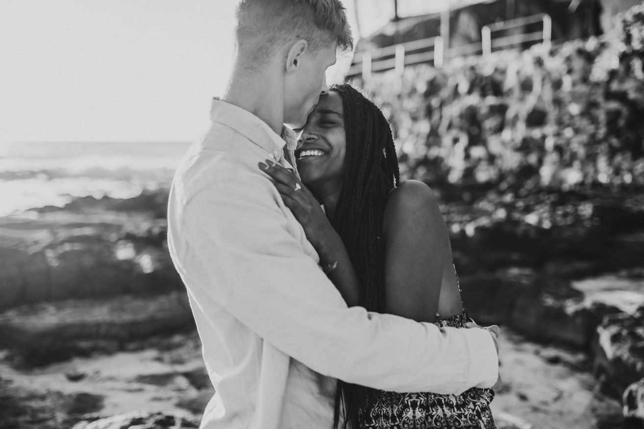 Black and white photo of a couple hugging and laughing