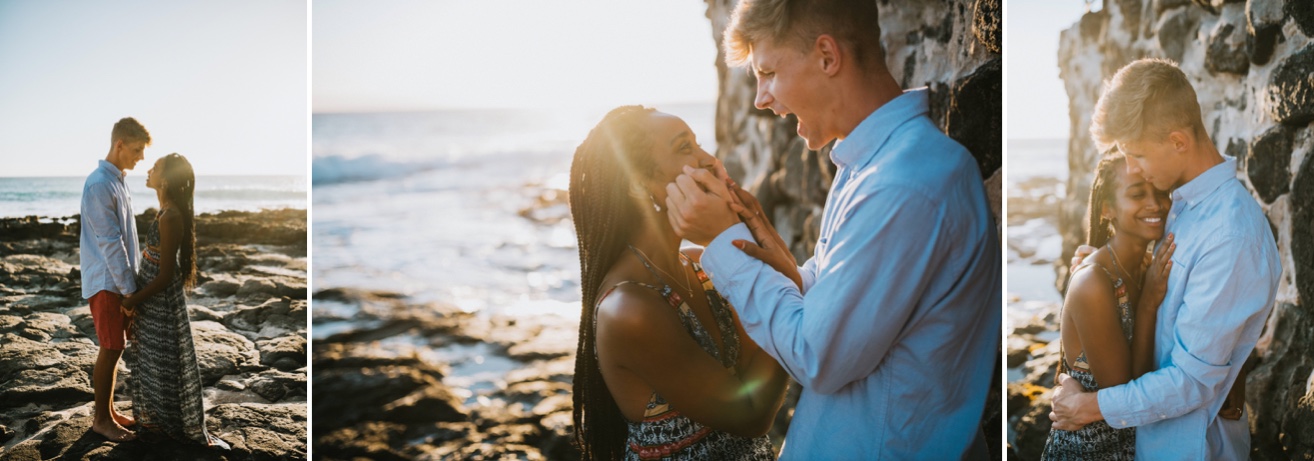 A man is playful holding his girlfriends cheeks while they look at each other and laugh during engagement session with a kona photographer