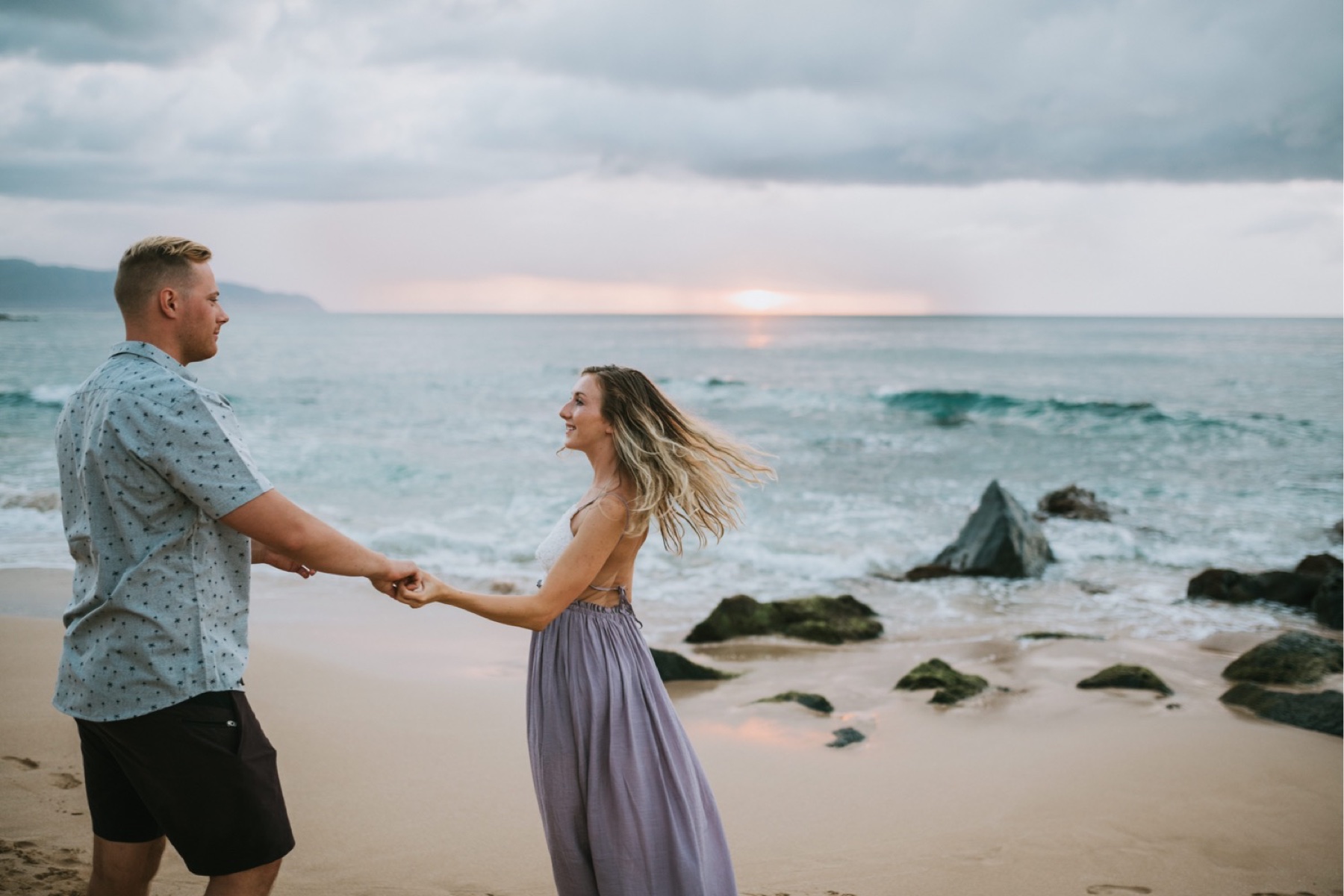 Couple dancing on the beach at sunset by a Hawaii Photographer