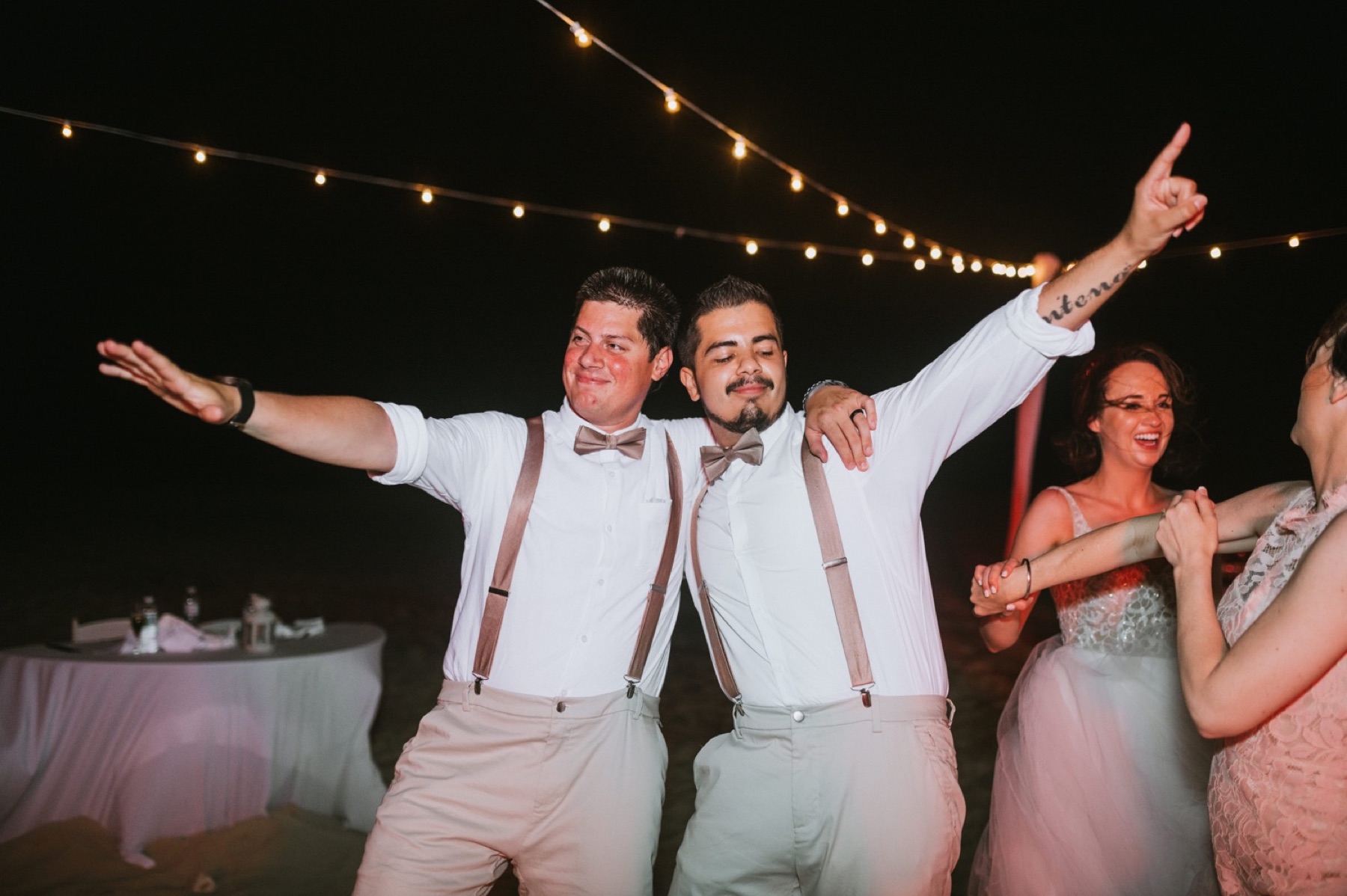 Groom and best man dancing during reception at hard rock punta cana