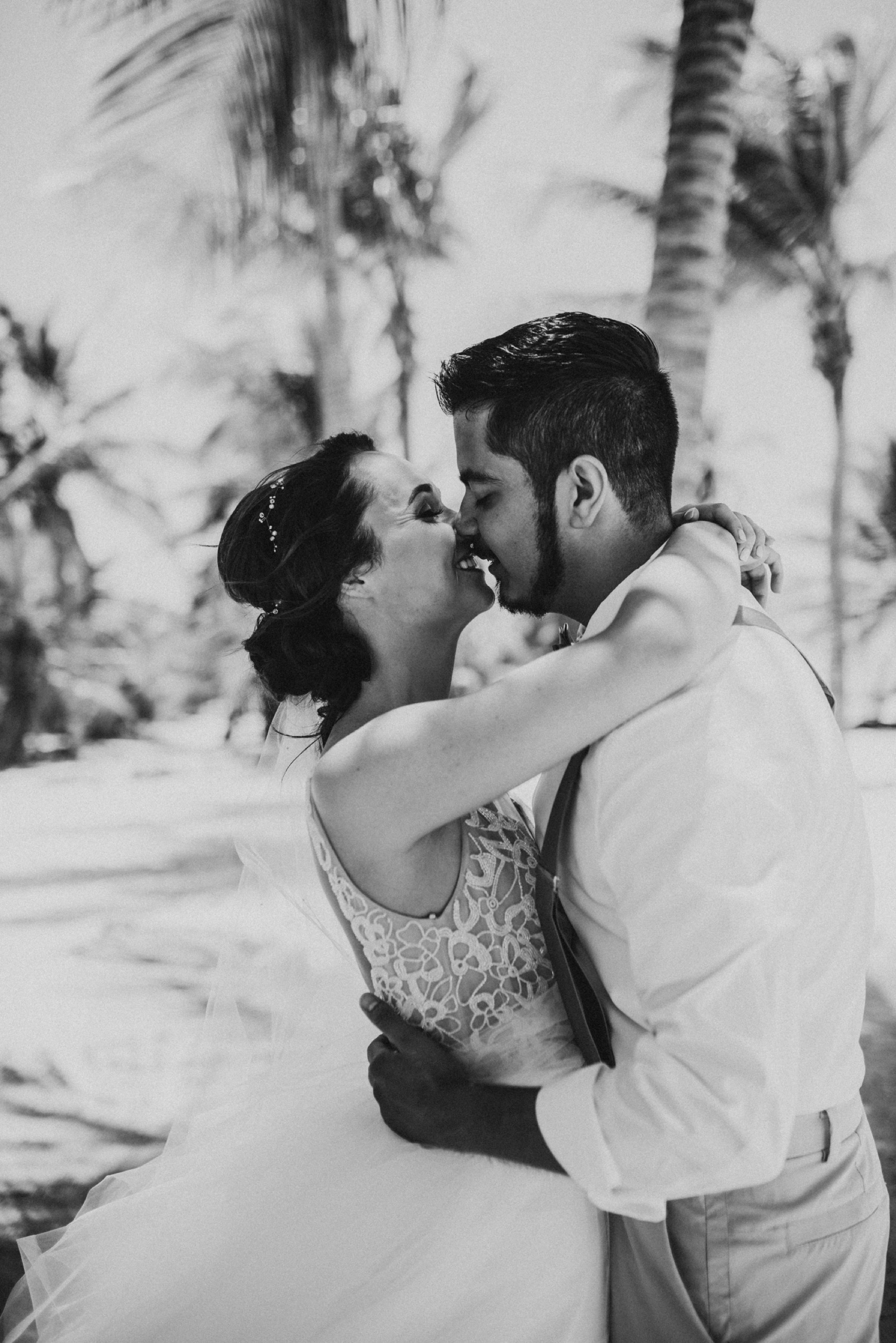 Black and white almost kiss in palm tree grove