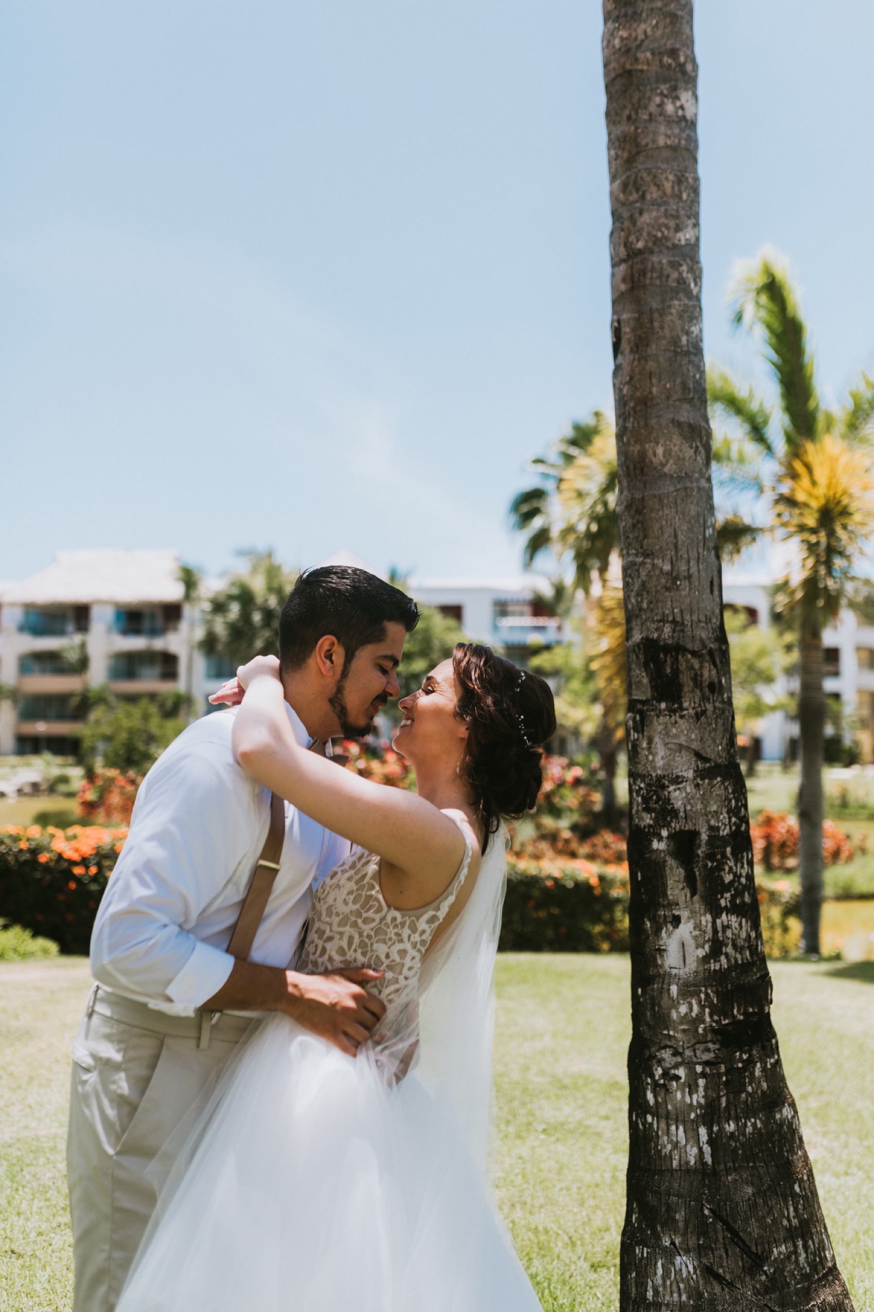 Couple almost kissing in hard rock punta cana gardens