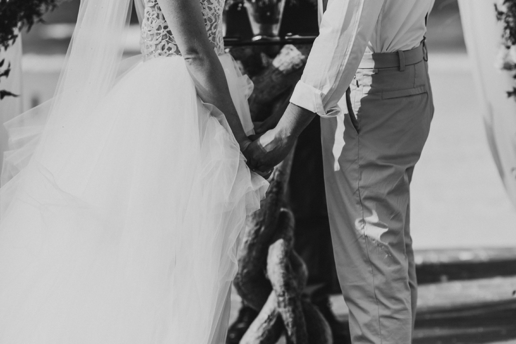 Black and white photos of couple holding hands at ceremony