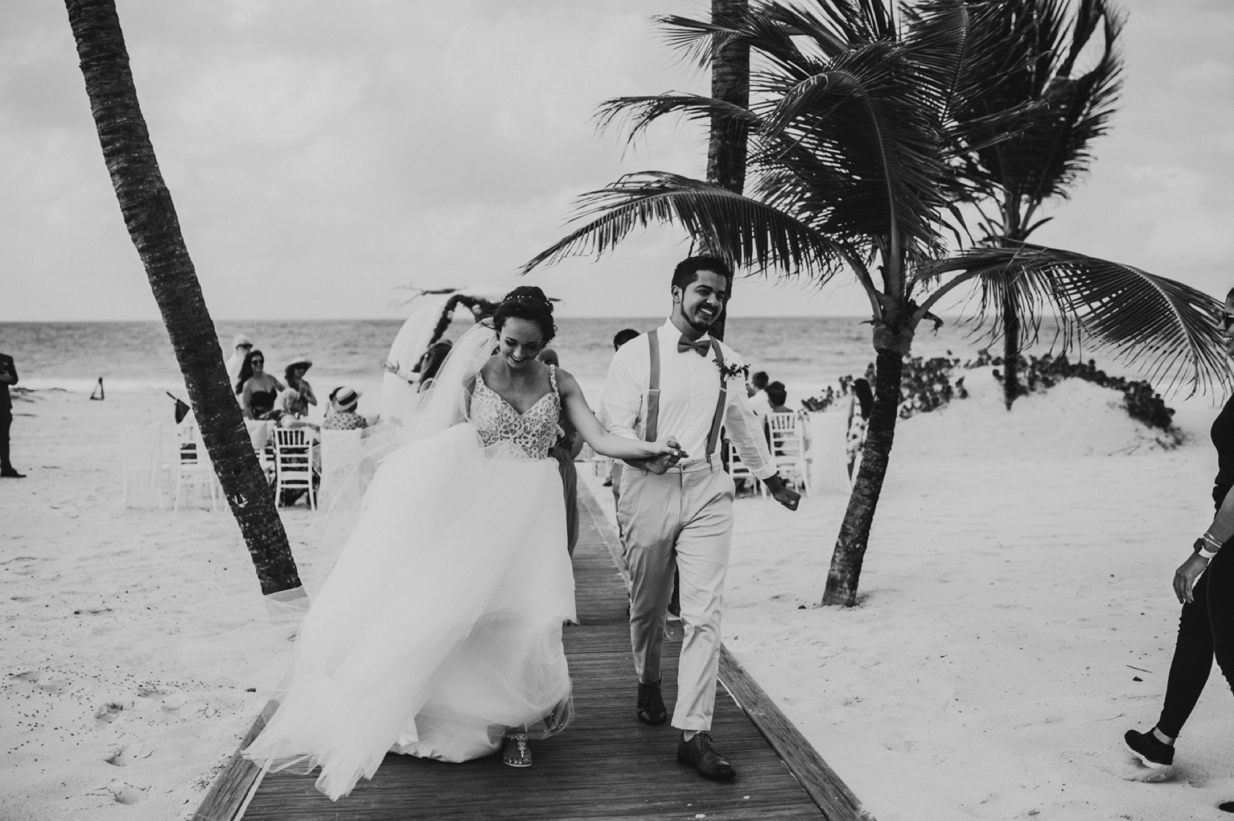 Black and white photo of couple walking back down the aisle at wedding at hard rock punta cana