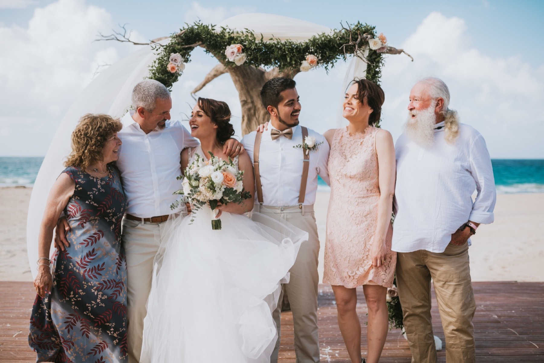 Fun family photo of bride and groom with brides family