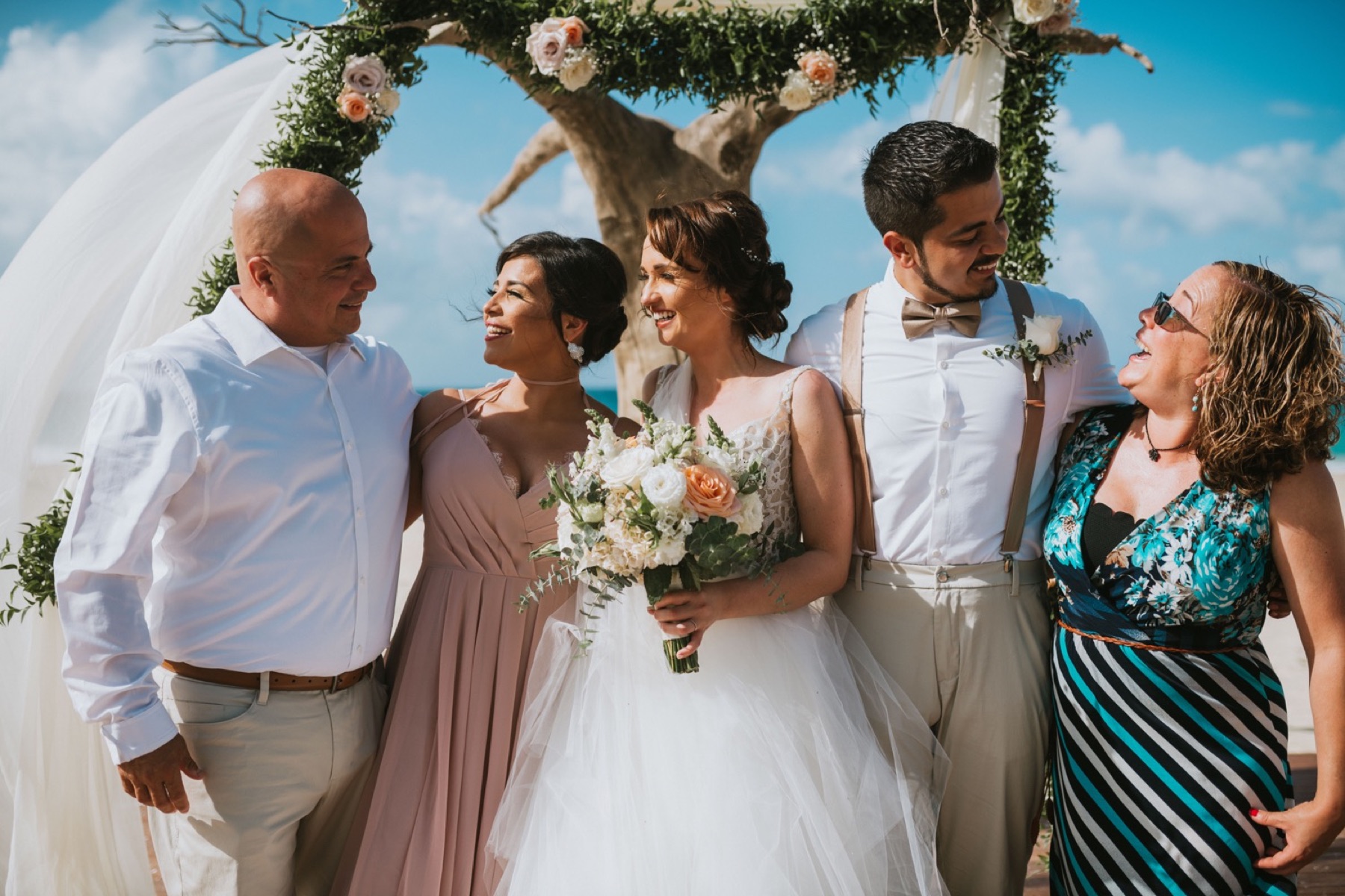 Fun family photo of bride and groom with grooms family