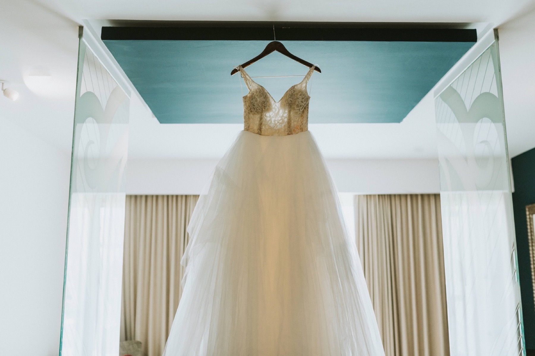 The brides wedding dress hanging in the hotel room at Hard Rock Punta Cana