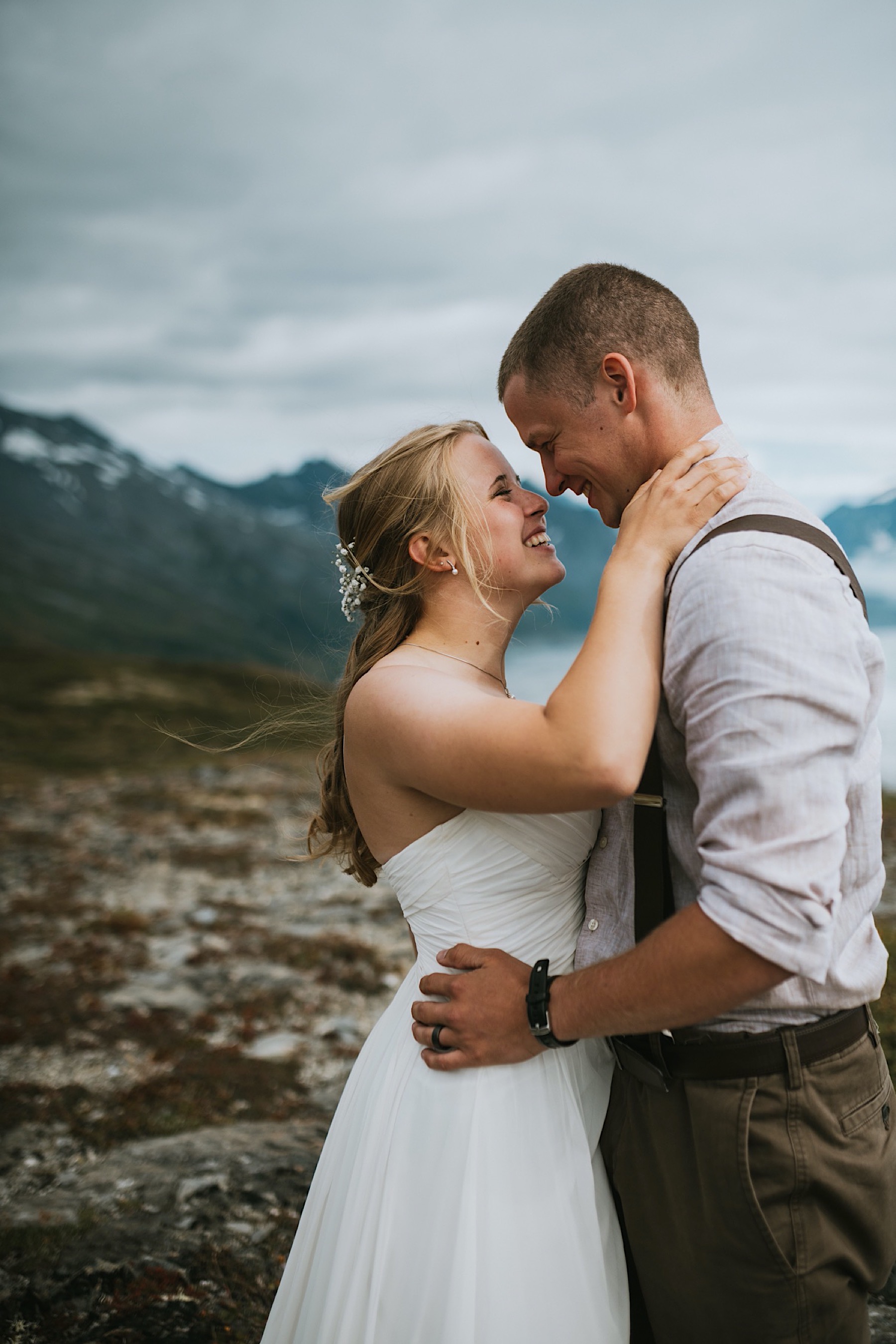 Bride and groom almost kissing in front of mountains during alaska destination wedding