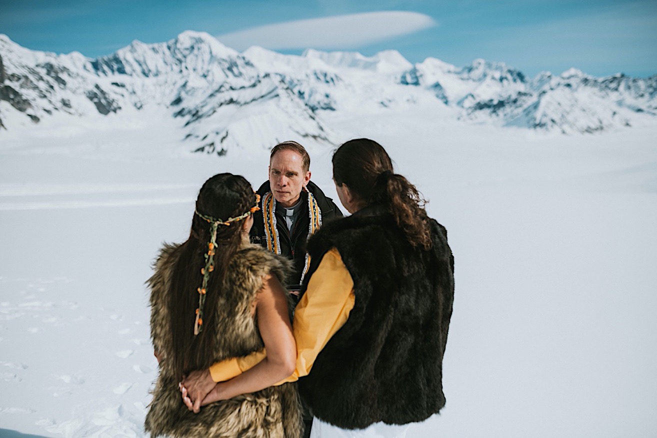 Groom wrapping his arm around his bride during their intimate glacier elopement