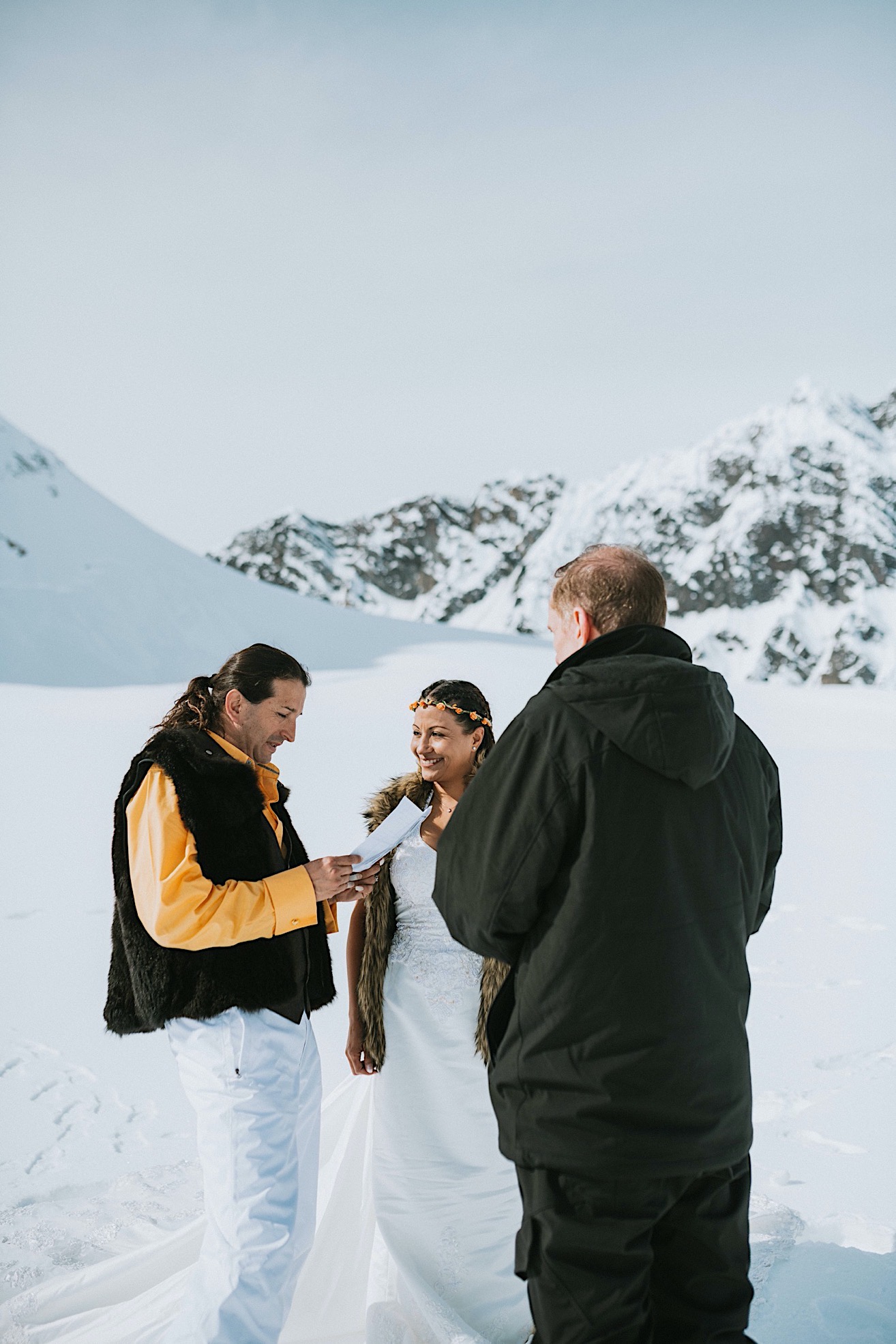 Groom reading his vows during intimate glacier elopement