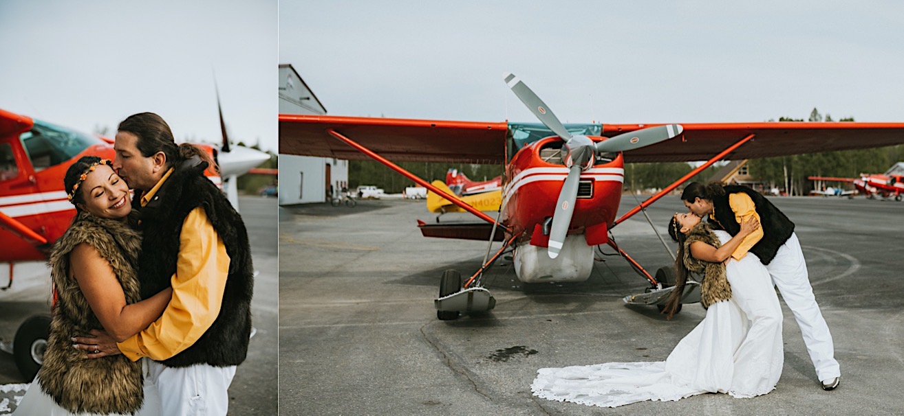 Couple dip kissing in front of red ski plane in Talkeetna at Sheldon Air Services