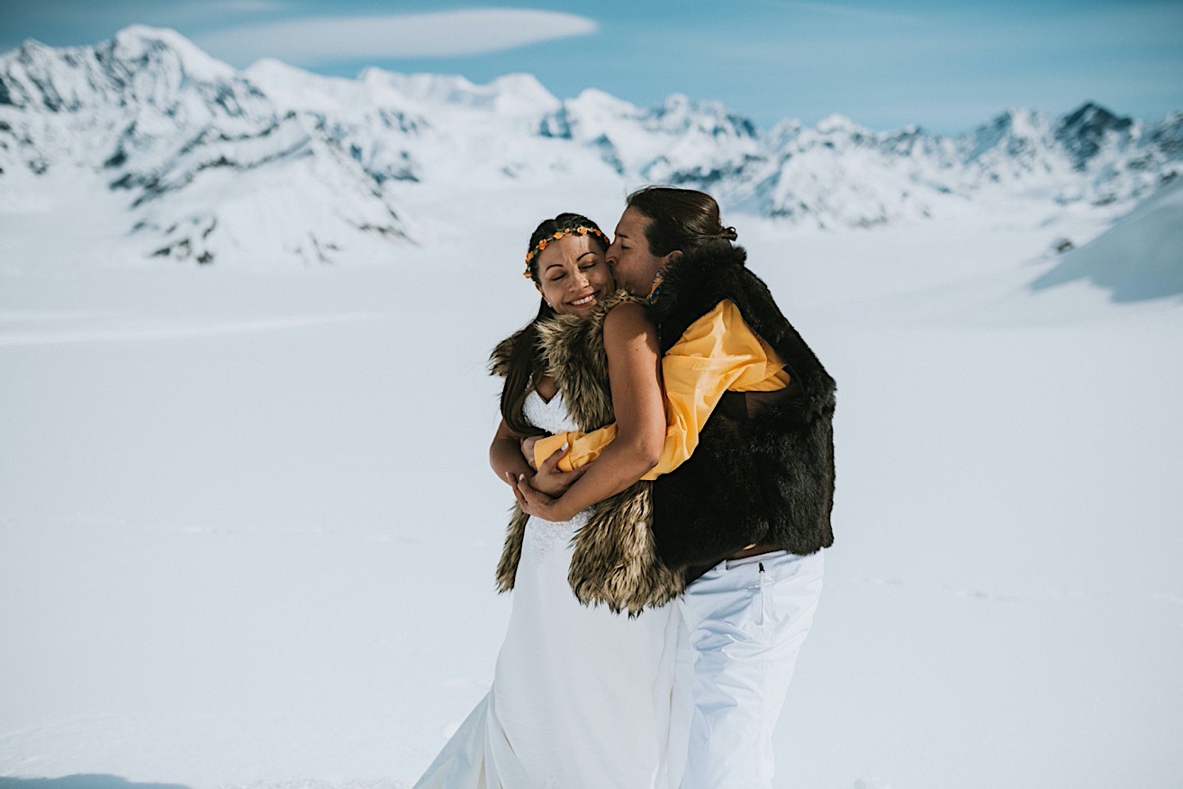 Groom bear hugging his bride after their glacier elopement in Denali National Park