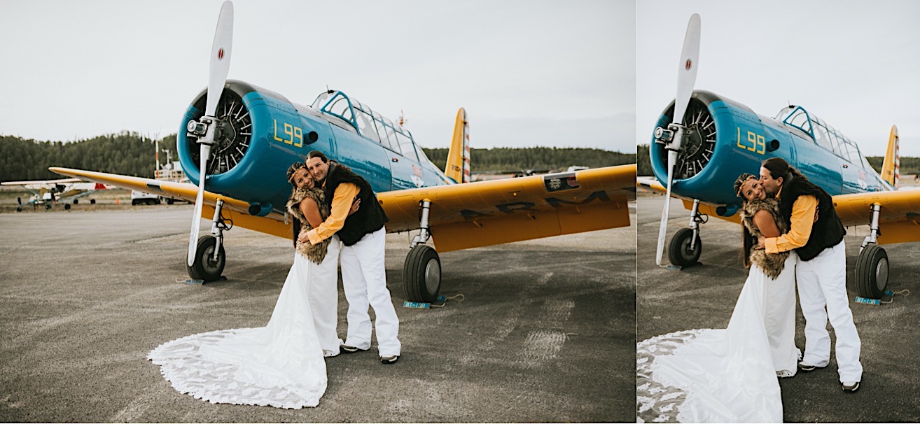 Couple snuggling and laughing in front of plane at Sheldon Air Services before their alaska glacier wedding