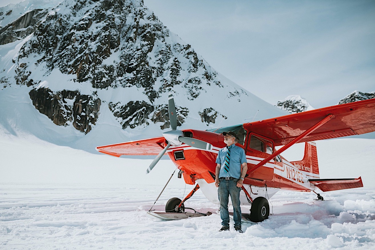Picture of sheldon air service pilot in front of his red plane