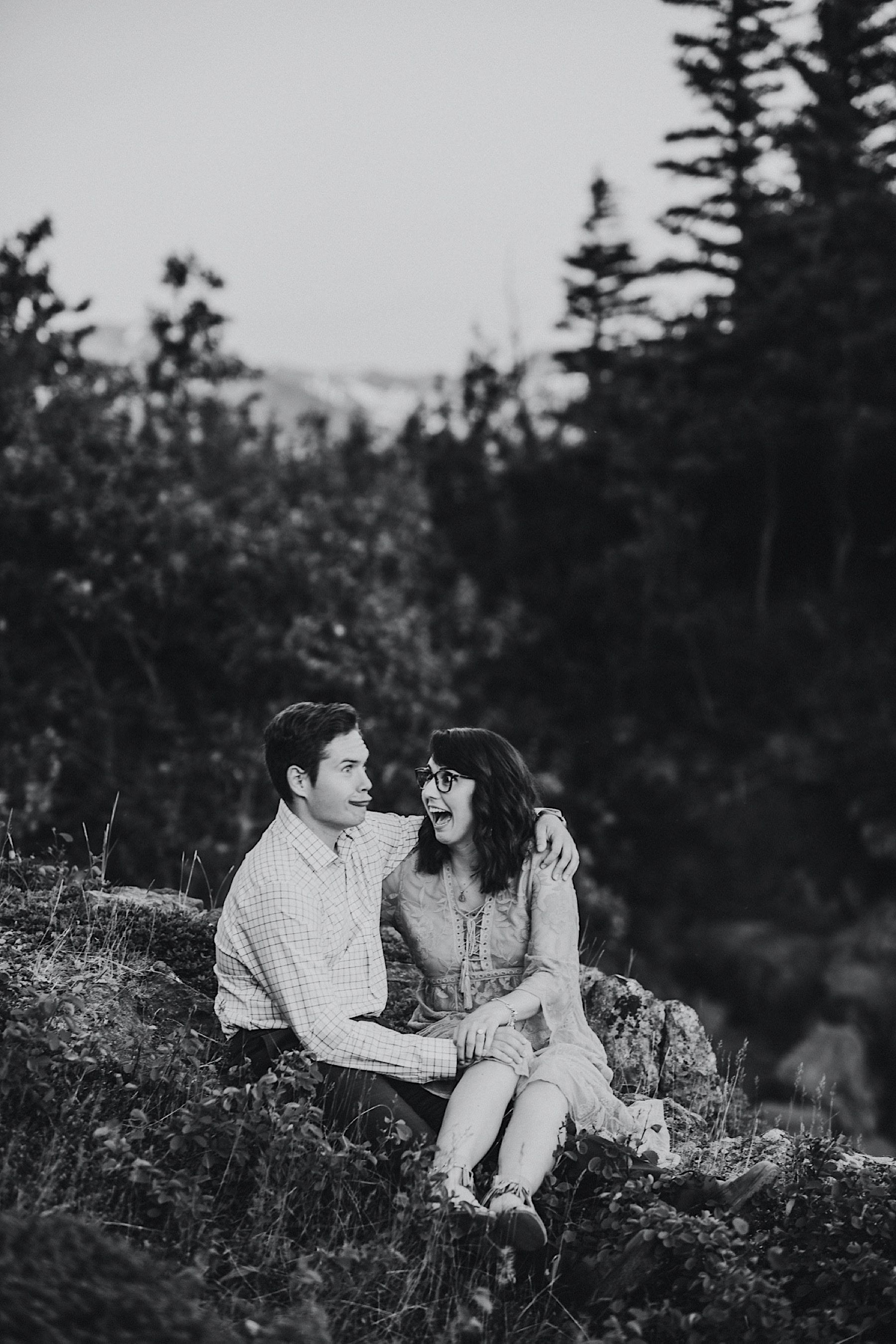 Black and white photo of couple making silly faces at each other