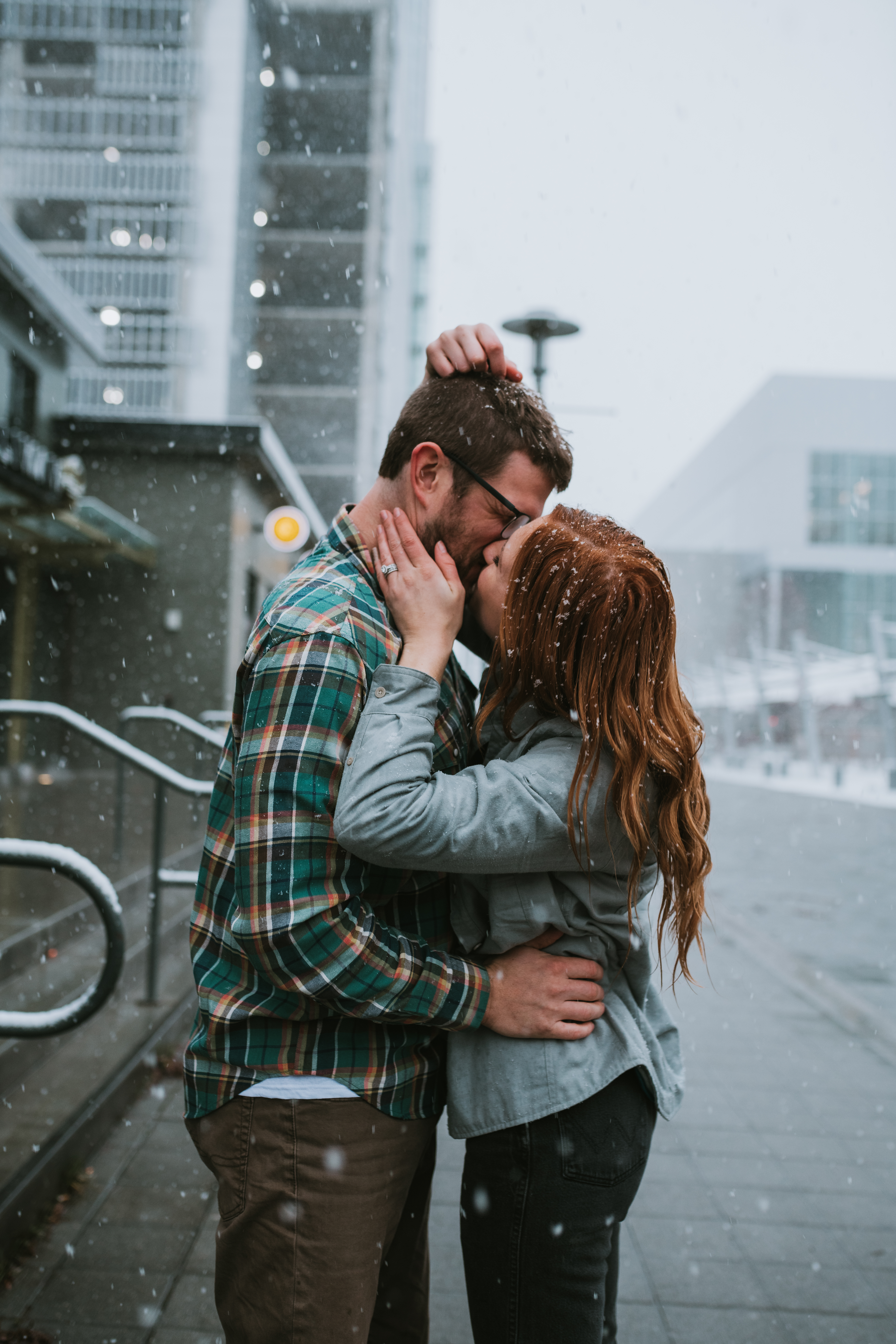 Couple kissing during wintery downtown Anchorage Alaska Engagement Photos